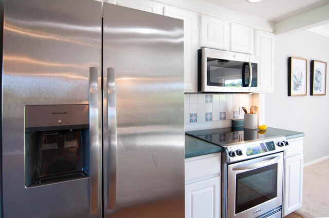 19578 Crystal Lake Dr, Northville, MI 48167 - kitchen with appliances with stainless steel finishes, decorative backsplash, white cabinetry, and dark countertops
