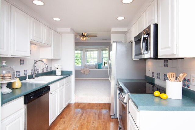 19578 Crystal Lake Dr, Northville, MI 48167 - kitchen with stainless steel appliances, a sink, ceiling fan, white cabinets, and recessed lighting