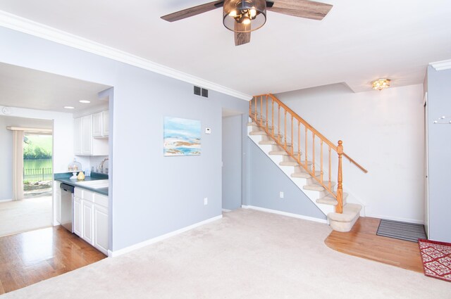 19578 Crystal Lake Dr, Northville, MI 48167 - unfurnished living room with stairway, ceiling fan, baseboards, light colored carpet, and crown molding