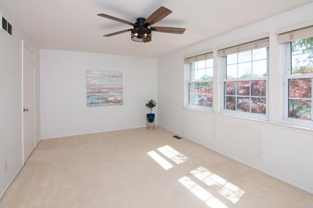 19578 Crystal Lake Dr, Northville, MI 48167 - unfurnished room with light colored carpet, plenty of natural light, ceiling fan, and baseboards