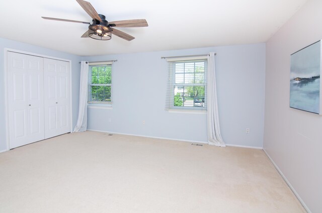 19578 Crystal Lake Dr, Northville, MI 48167 - unfurnished bedroom with multiple windows, light colored carpet, a closet, and baseboards