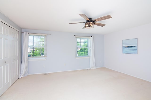 19578 Crystal Lake Dr, Northville, MI 48167 - unfurnished bedroom with light colored carpet, a closet, baseboards, and a ceiling fan