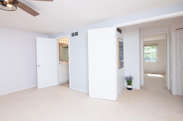 19578 Crystal Lake Dr, Northville, MI 48167 - unfurnished bedroom featuring light colored carpet, connected bathroom, and ceiling fan