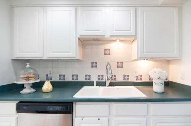 19578 Crystal Lake Dr, Northville, MI 48167 - kitchen featuring dishwasher, dark countertops, white cabinetry, a sink, and decorative backsplash