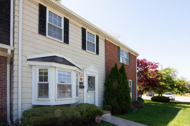 19578 Crystal Lake Dr, Northville, MI 48167 - view of front facade with a front yard and brick siding