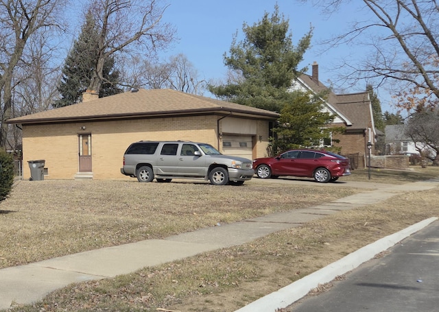 4344 10th St, Ecorse, MI 48229 - view of side of home with brick siding, a chimney, roof with shingles, and concrete driveway