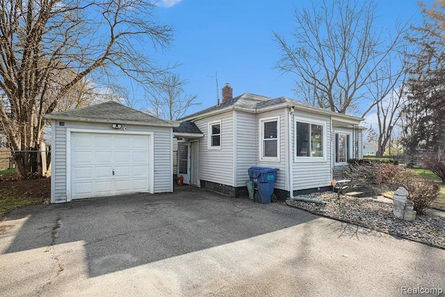 236 Helmar Ct, Benton Harbor, MI 49022 - view of home's exterior with a chimney and driveway