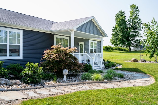 30877 County Road 687, Bangor, MI 49013 - view of exterior entry featuring roof with shingles, covered porch, and a yard