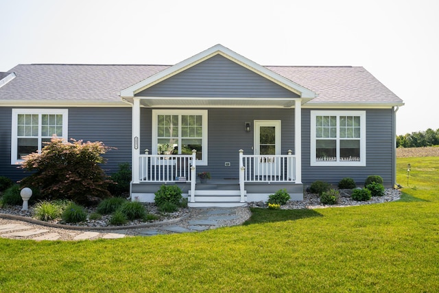 30877 County Road 687, Bangor, MI 49013 - view of front of house with covered porch, a front lawn, and roof with shingles