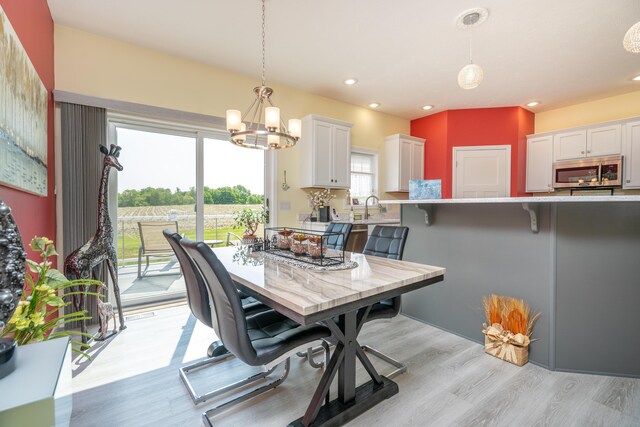 30877 County Road 687, Bangor, MI 49013 - dining space featuring plenty of natural light, light wood finished floors, a chandelier, and recessed lighting