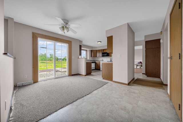 2045 E Baldwin Rd, Grand Blanc, MI 48439 - unfurnished living room featuring ceiling fan and baseboards
