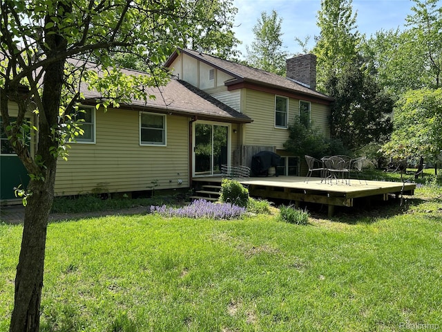 1690 Cedar Knoll Ln, Caro, MI 48723 - rear view of house featuring a chimney, a lawn, a wooden deck, and a shingled roof