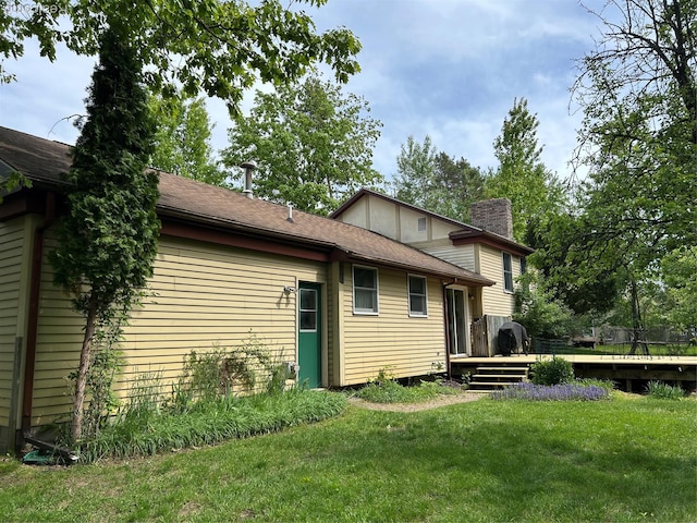 1690 Cedar Knoll Ln, Caro, MI 48723 - back of property featuring a chimney, a deck, and a lawn
