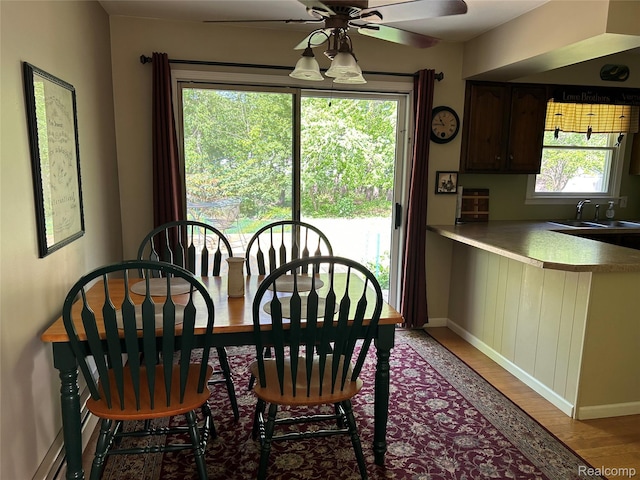1690 Cedar Knoll Ln, Caro, MI 48723 - dining area with light wood-style flooring, a ceiling fan, and baseboards
