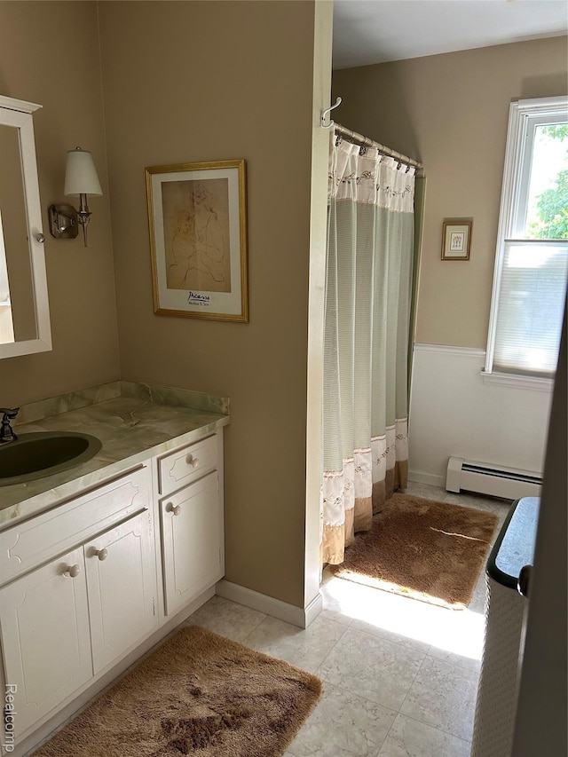 1690 Cedar Knoll Ln, Caro, MI 48723 - full bathroom with a baseboard radiator, vanity, a shower with shower curtain, and baseboards