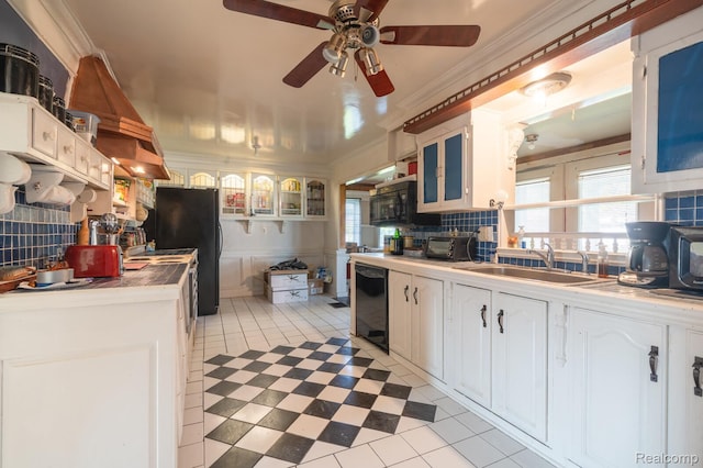 511 N Byfield St, Westland, MI 48185 - kitchen featuring a sink, a ceiling fan, tasteful backsplash, black appliances, and glass insert cabinets