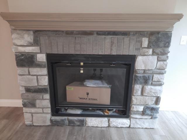 16445 Sleepy Hollow Dr, Fenton, MI 48430 - detailed view of a glass covered fireplace and wood finished floors