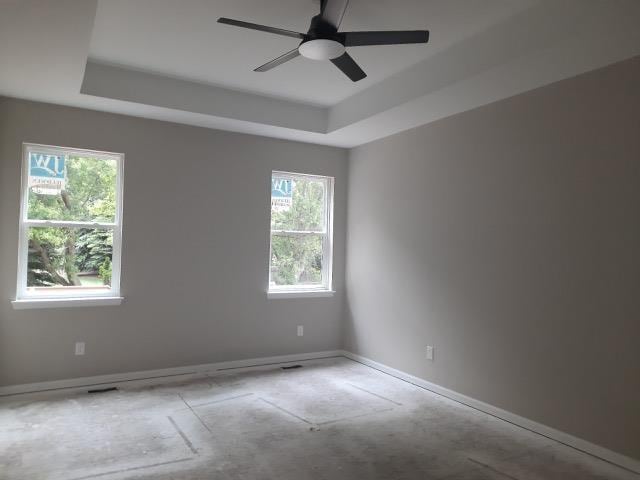 16445 Sleepy Hollow Dr, Fenton, MI 48430 - spare room featuring a ceiling fan and a raised ceiling