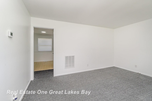 4675 E Parish Rd, Midland, MI 48642 - empty room featuring dark carpet and baseboards