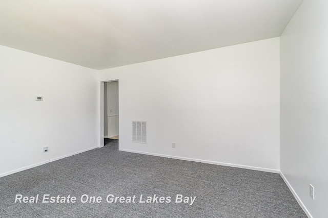 4675 E Parish Rd, Midland, MI 48642 - spare room with dark carpet and baseboards