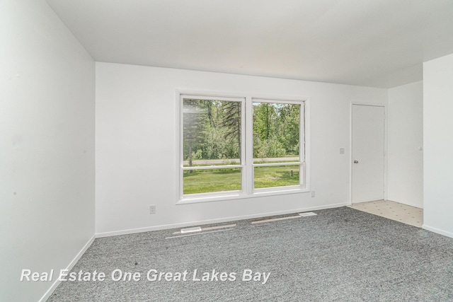 4675 E Parish Rd, Midland, MI 48642 - carpeted empty room with baseboards