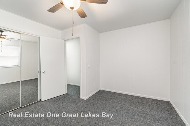 4675 E Parish Rd, Midland, MI 48642 - unfurnished bedroom with carpet floors, a ceiling fan, a closet, and baseboards
