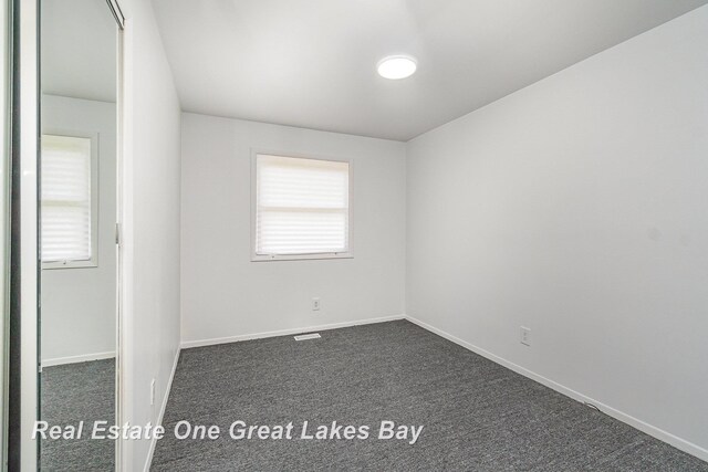 4675 E Parish Rd, Midland, MI 48642 - unfurnished room with dark carpet and baseboards