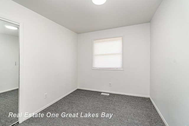 4675 E Parish Rd, Midland, MI 48642 - unfurnished room featuring dark colored carpet and baseboards