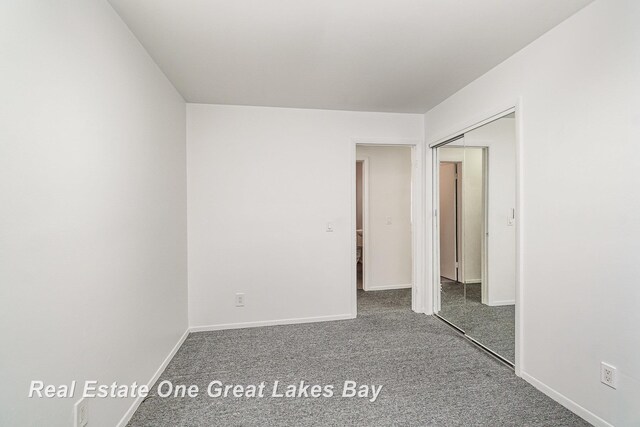 4675 E Parish Rd, Midland, MI 48642 - empty room with carpet floors and baseboards