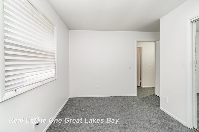 4675 E Parish Rd, Midland, MI 48642 - empty room with dark colored carpet and baseboards