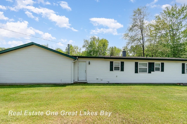 4675 E Parish Rd, Midland, MI 48642 - rear view of house featuring a yard and a chimney