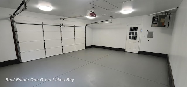 4675 E Parish Rd, Midland, MI 48642 - garage featuring a garage door opener, a heating unit, and baseboards