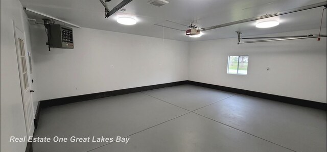 4675 E Parish Rd, Midland, MI 48642 - garage with a heating unit, a garage door opener, and baseboards