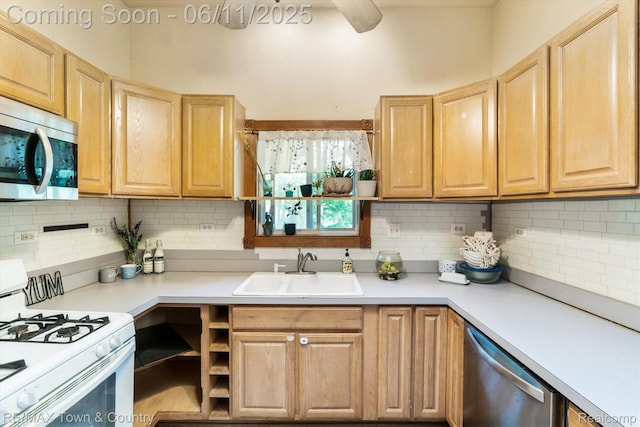 3244 Huggins Ave, Flint, MI 48506 - kitchen featuring stainless steel appliances, a sink, light brown cabinetry, and tasteful backsplash