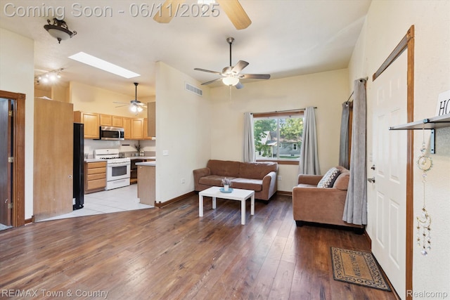 3244 Huggins Ave, Flint, MI 48506 - living area with a ceiling fan, light wood-type flooring, a skylight, and baseboards