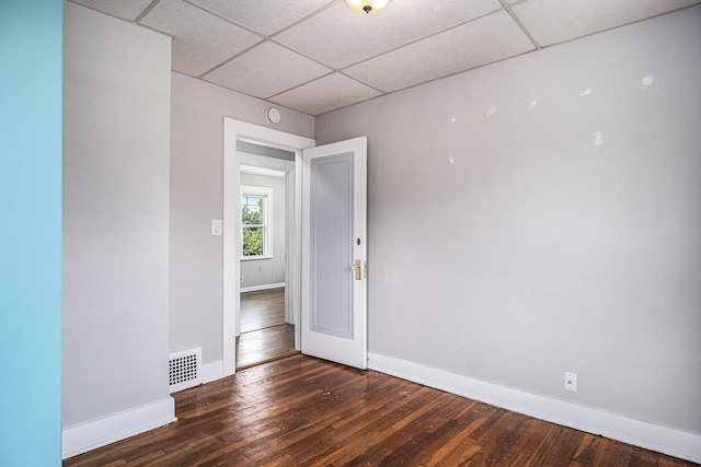 75 Diamond Ave NE, Grand Rapids, MI 49503 - empty room featuring a paneled ceiling, baseboards, and hardwood / wood-style flooring