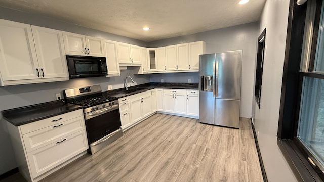 30 Zuidema Ct, Kalamazoo, MI 49001 - kitchen featuring stainless steel appliances, a sink, light wood-type flooring, recessed lighting, and white cabinetry