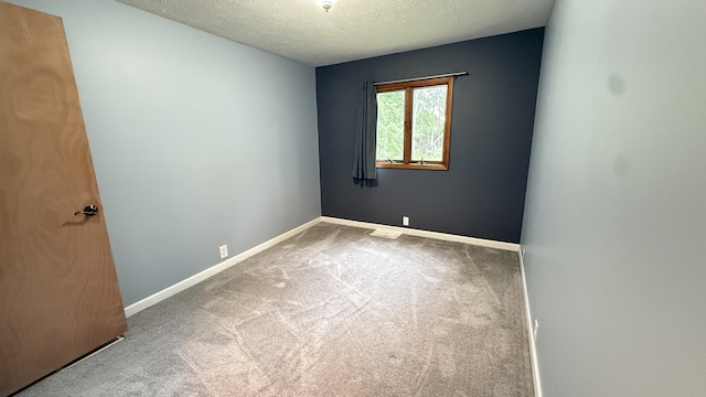 30 Zuidema Ct, Kalamazoo, MI 49001 - spare room featuring carpet flooring, baseboards, and a textured ceiling