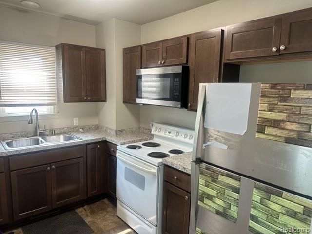 164 E Hamilton Ave, Flint, MI 48505 - kitchen with appliances with stainless steel finishes and dark brown cabinets