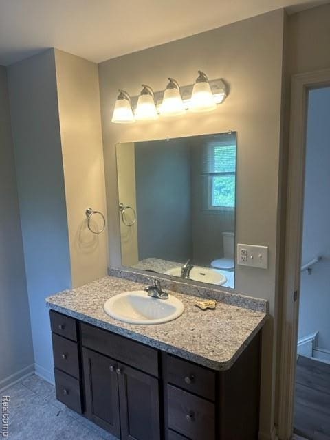164 E Hamilton Ave, Flint, MI 48505 - bathroom with vanity and baseboards
