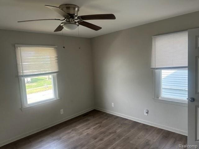 164 E Hamilton Ave, Flint, MI 48505 - spare room with dark wood-style floors and a ceiling fan