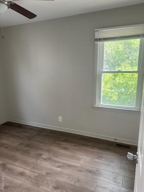164 E Hamilton Ave, Flint, MI 48505 - spare room featuring wood finished floors and ceiling fan