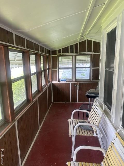 164 E Hamilton Ave, Flint, MI 48505 - unfurnished sunroom featuring lofted ceiling and wood walls