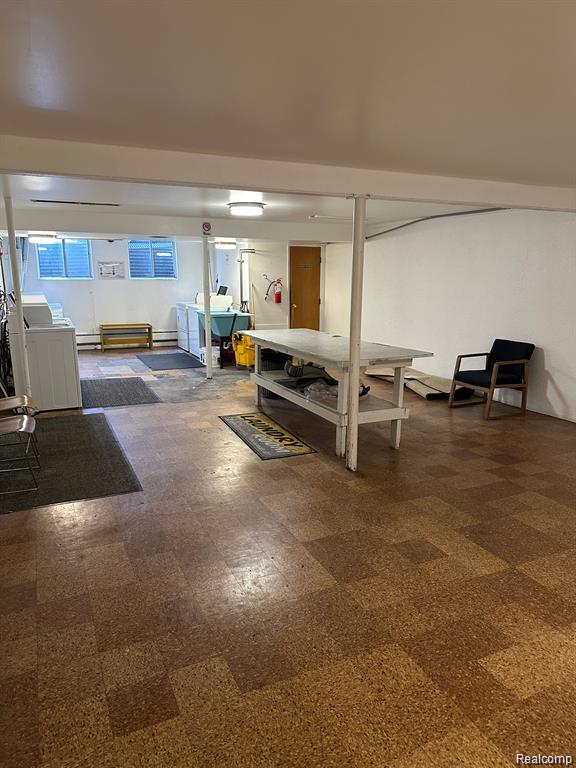 25301 5 Mile Rd, Detroit, MI 48239 - basement with dark flooring and baseboard heating