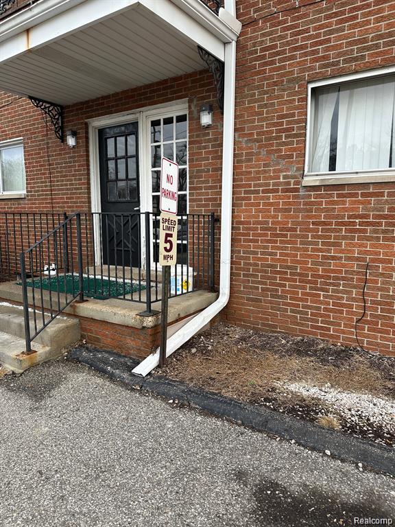 25301 5 Mile Rd, Detroit, MI 48239 - view of exterior entry featuring brick siding