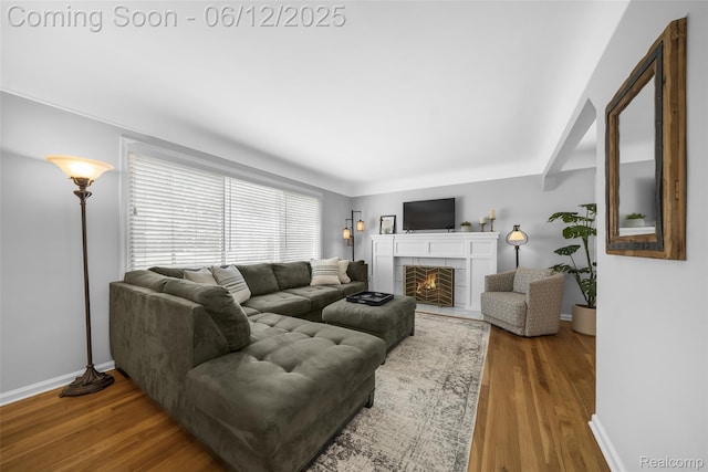 2195 Pembroke Rd, Birmingham, MI 48009 - living area with baseboards, wood finished floors, and a tiled fireplace