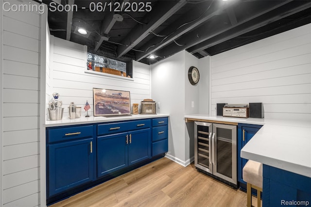 2195 Pembroke Rd, Birmingham, MI 48009 - indoor dry bar with beverage cooler, wood walls, and light wood-type flooring