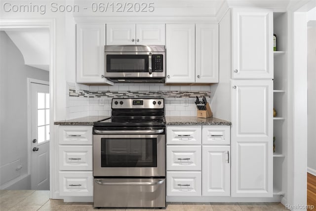2195 Pembroke Rd, Birmingham, MI 48009 - kitchen featuring stainless steel appliances, white cabinets, dark stone counters, and open shelves