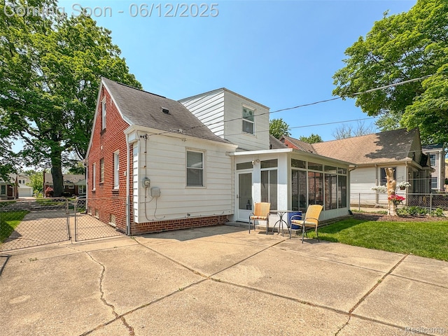 2195 Pembroke Rd, Birmingham, MI 48009 - rear view of property with a sunroom, a patio, a shingled roof, and a gate