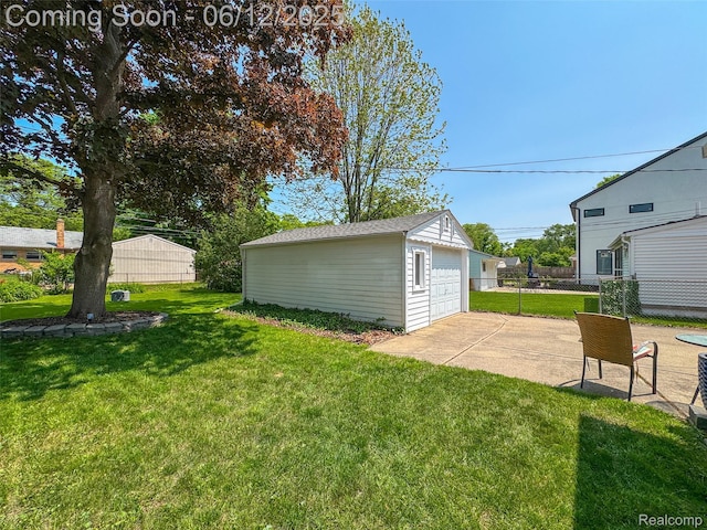 2195 Pembroke Rd, Birmingham, MI 48009 - view of yard featuring a garage, an outbuilding, and a patio area